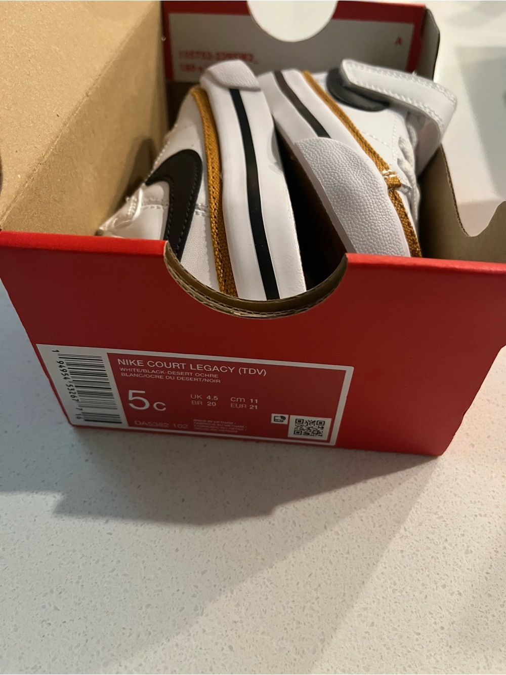 Nike Kids Sneakers in White with Black and Gold Accents